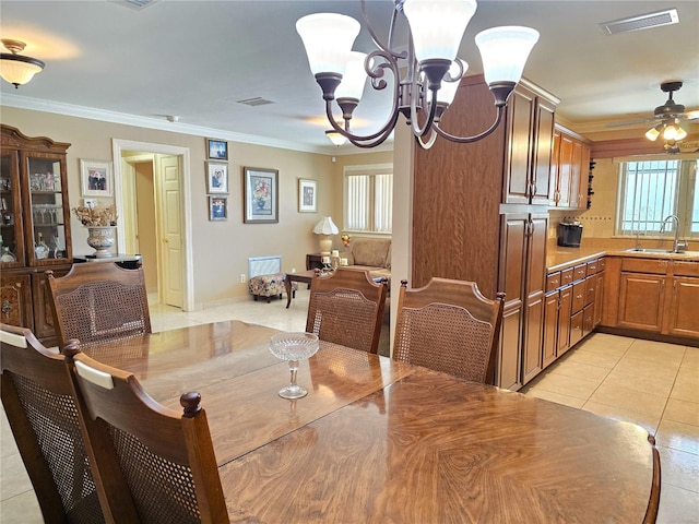 dining room with crown molding, light tile patterned floors, ceiling fan with notable chandelier, and visible vents