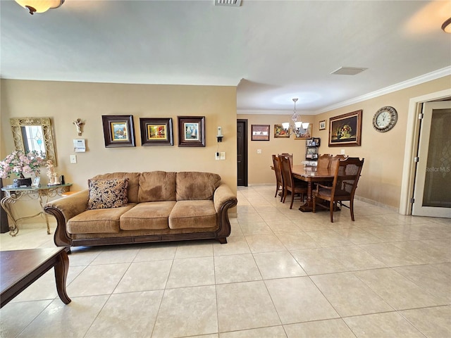 living room with crown molding, light tile patterned flooring, visible vents, and a chandelier