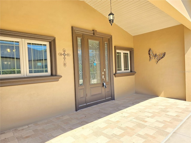 entrance to property with stucco siding