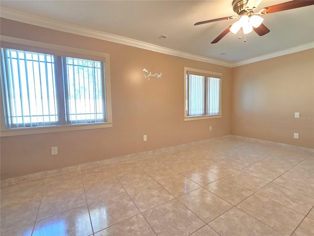 tiled empty room featuring ceiling fan, baseboards, and ornamental molding