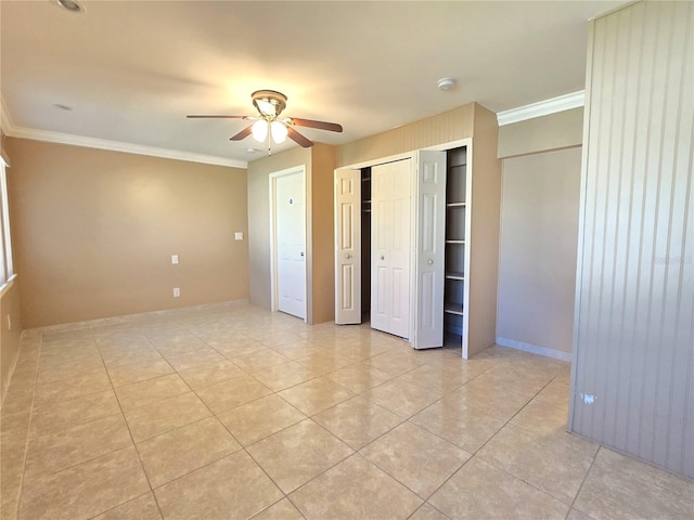 unfurnished bedroom with light tile patterned floors, baseboards, and crown molding