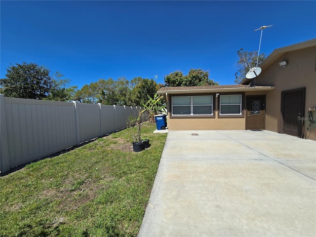 view of yard with a patio area and a fenced backyard