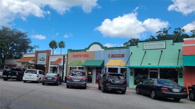 view of building exterior with uncovered parking