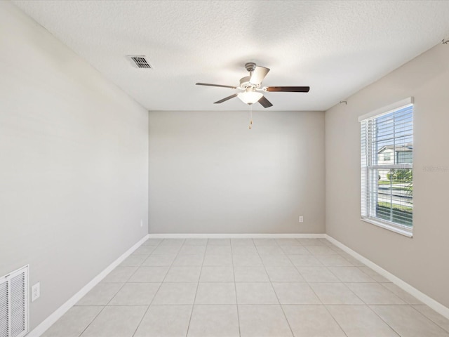 empty room with visible vents, baseboards, a textured ceiling, and ceiling fan