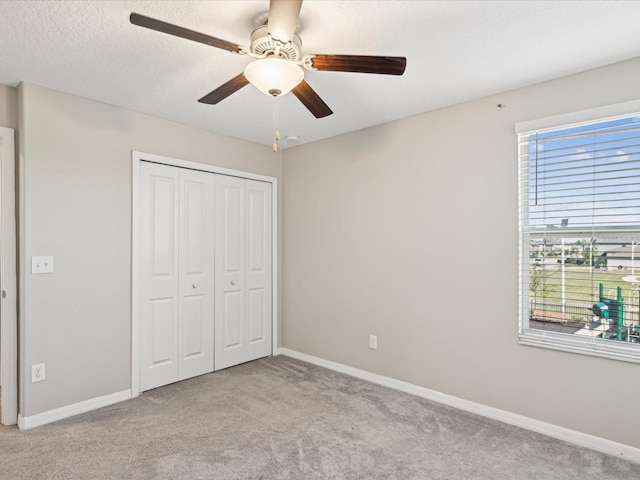 unfurnished bedroom featuring a closet, baseboards, and carpet