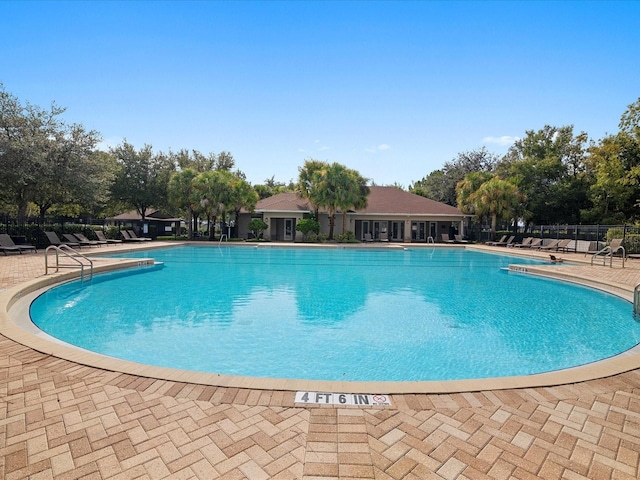 pool featuring a patio and fence