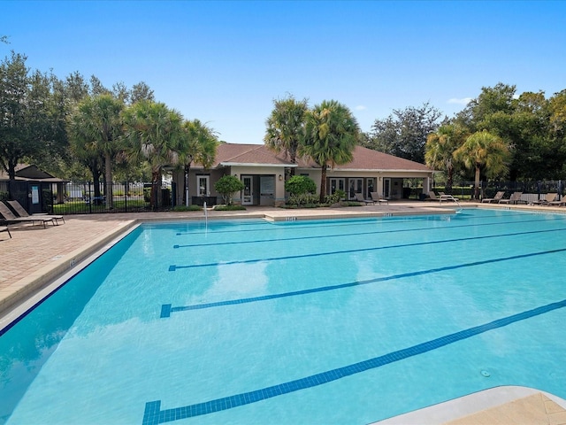 community pool featuring a patio area and fence