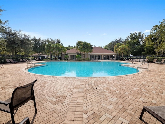 pool featuring a patio area and fence