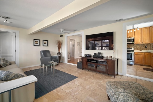 living room featuring visible vents, baseboards, beam ceiling, light tile patterned floors, and a ceiling fan