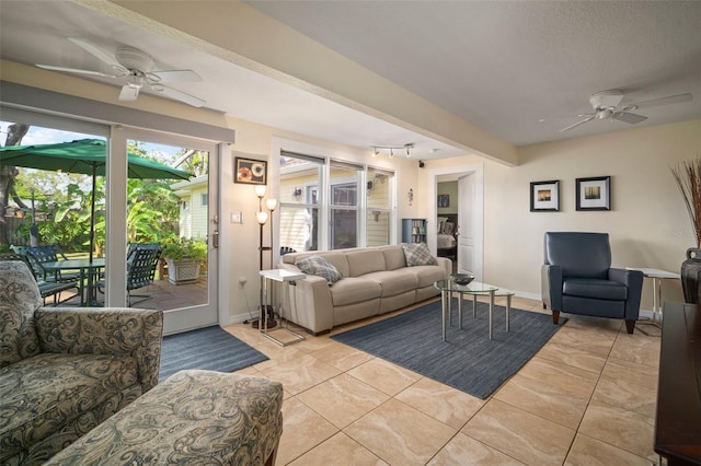 living room featuring baseboards, ceiling fan, and track lighting