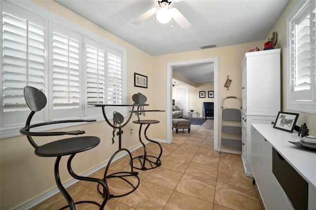 dining room featuring baseboards, visible vents, and ceiling fan