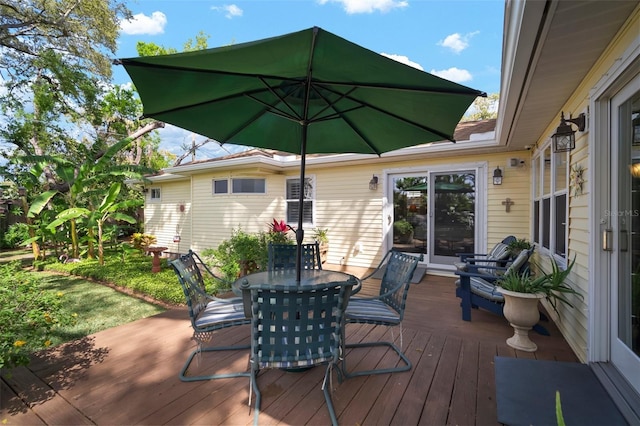 wooden terrace featuring outdoor dining area