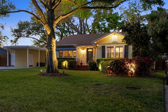 view of front of home with a front lawn and a carport