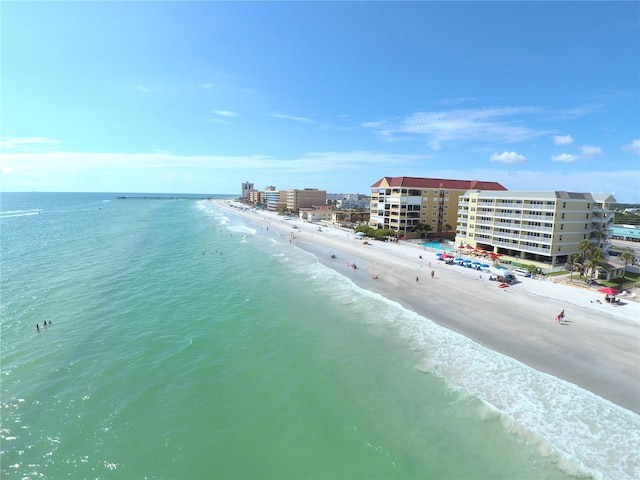 drone / aerial view with a water view, a view of city, and a beach view