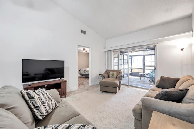 living area with visible vents, light carpet, high vaulted ceiling, a ceiling fan, and baseboards