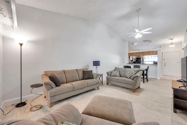 living area featuring visible vents, baseboards, lofted ceiling, and a ceiling fan