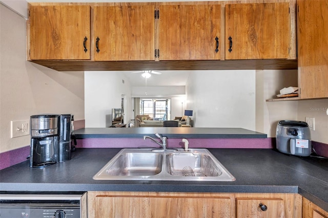 kitchen with a sink, dark countertops, open floor plan, dishwashing machine, and ceiling fan