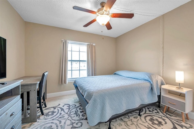 bedroom with a textured ceiling, baseboards, and ceiling fan