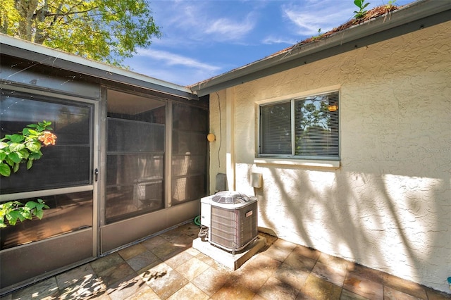 exterior space featuring stucco siding and central AC