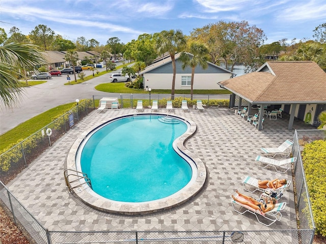 pool featuring a patio and fence