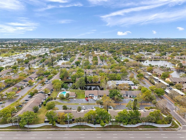 drone / aerial view featuring a water view and a residential view