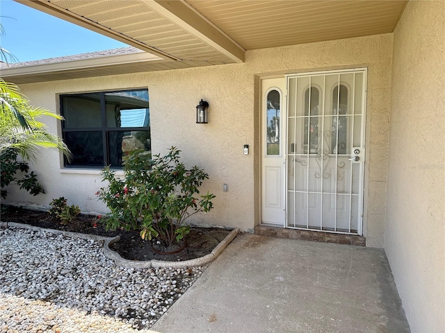 doorway to property with stucco siding