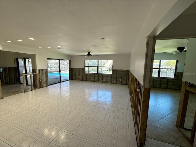 tiled spare room with recessed lighting, wainscoting, and ceiling fan