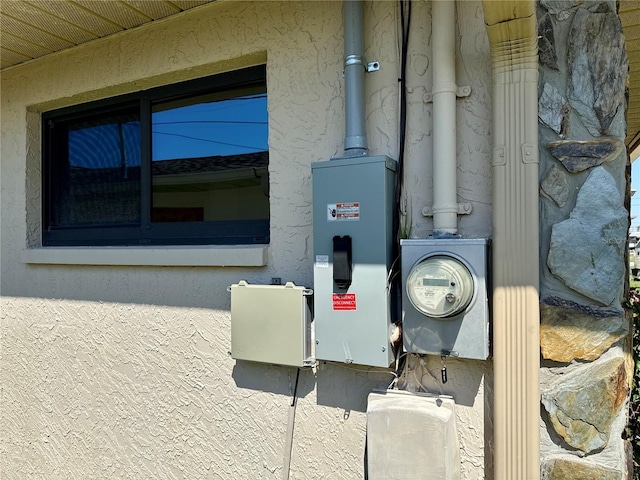 details with electric meter and stucco siding