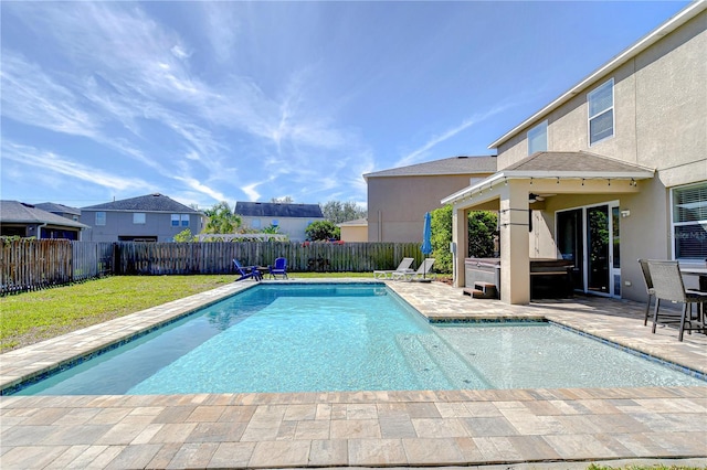 view of swimming pool featuring a patio area, a fenced backyard, a lawn, and ceiling fan