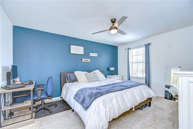 bedroom with baseboards, carpet floors, and a textured ceiling