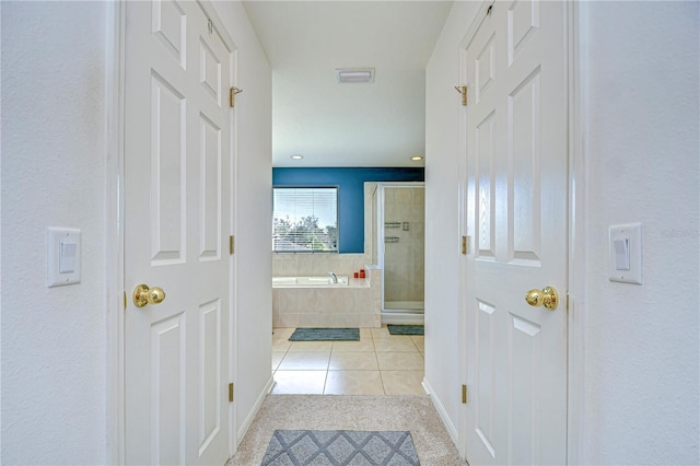 corridor with tile patterned floors and visible vents