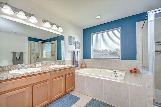 bathroom with tile patterned flooring, a garden tub, a stall shower, and a sink