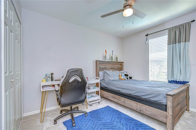 carpeted bedroom featuring a closet, baseboards, and ceiling fan