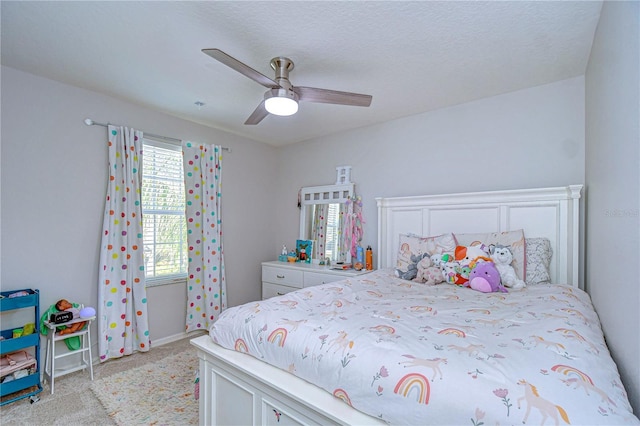 bedroom featuring ceiling fan and light carpet