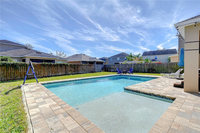 view of swimming pool featuring a fenced in pool, a patio, a lawn, and a fenced backyard