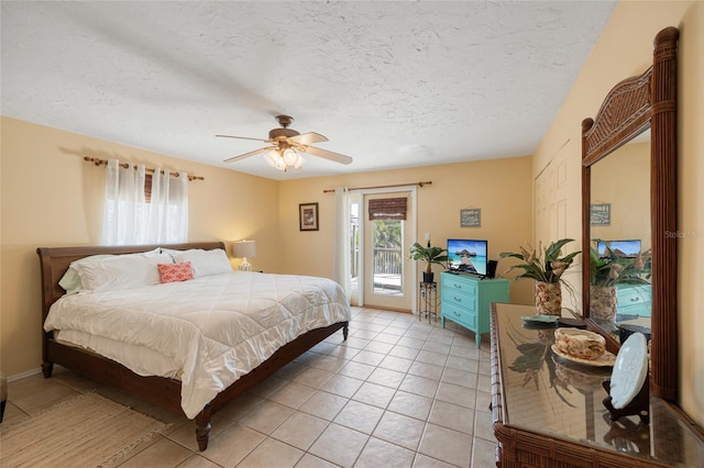 bedroom featuring access to outside, multiple windows, light tile patterned floors, and a textured ceiling