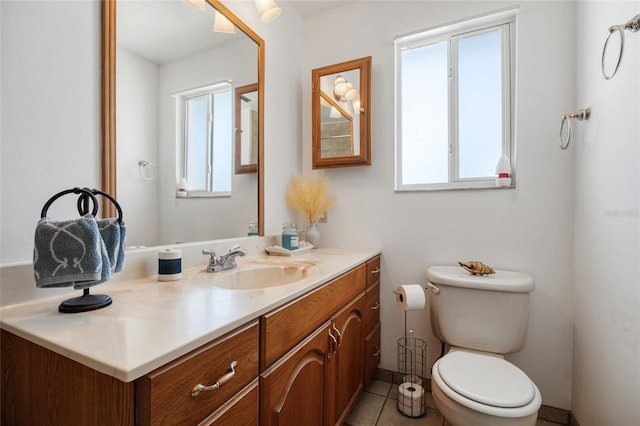 bathroom featuring vanity, toilet, and tile patterned flooring