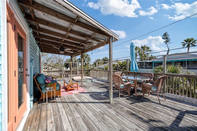 deck with ceiling fan and outdoor dining space