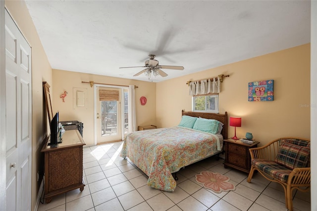 bedroom with light tile patterned flooring, multiple windows, ceiling fan, and access to outside