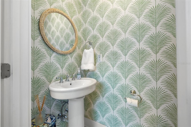 half bathroom with wallpapered walls