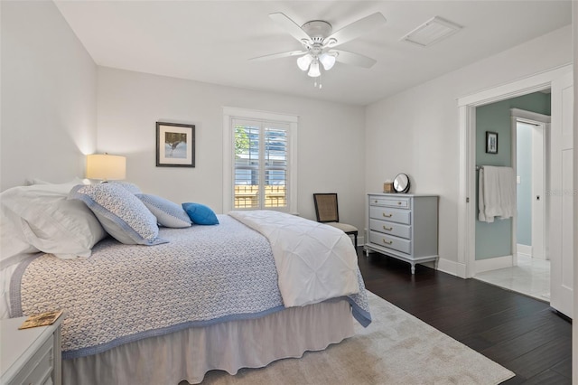 bedroom with visible vents, dark wood-style flooring, ceiling fan, and baseboards