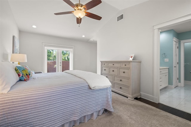 bedroom featuring access to exterior, baseboards, ensuite bathroom, lofted ceiling, and visible vents