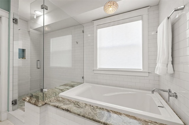 bathroom with a shower stall and a garden tub