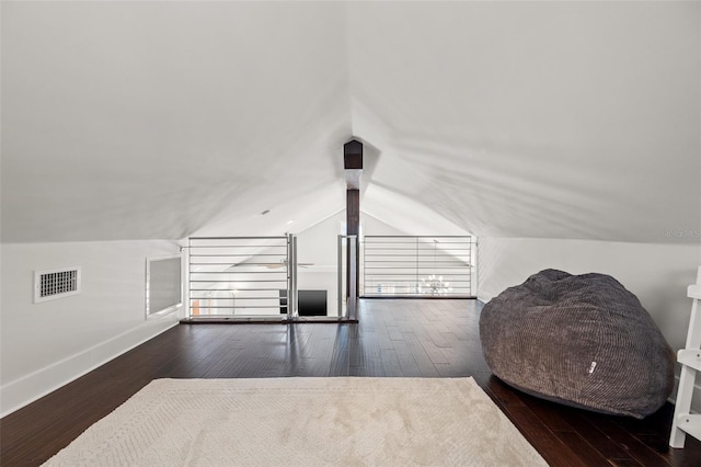 bonus room with baseboards, wood-type flooring, vaulted ceiling, and visible vents