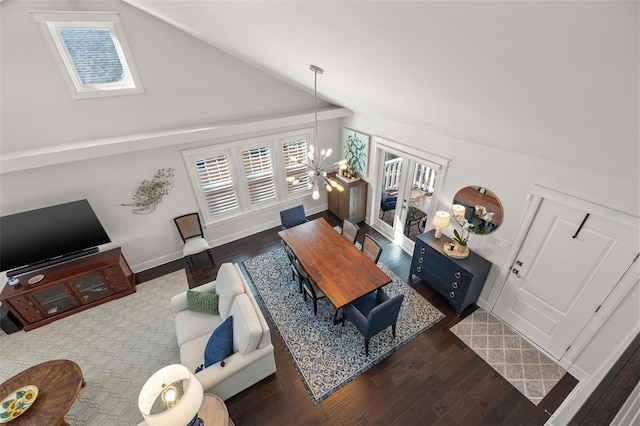 living area featuring baseboards, vaulted ceiling, and wood finished floors