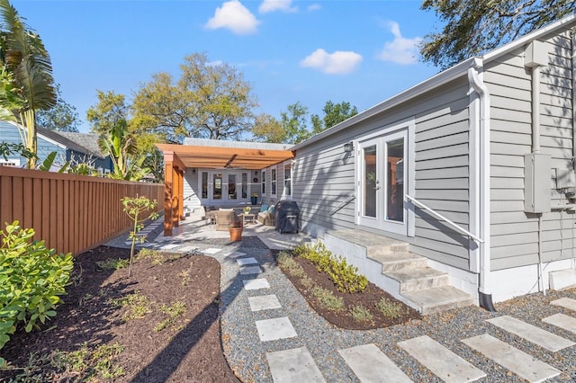 back of property with fence, french doors, a patio area, and entry steps