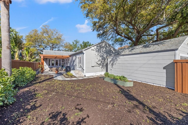 view of yard with fence and a patio