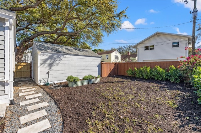 view of yard with fence and an outbuilding