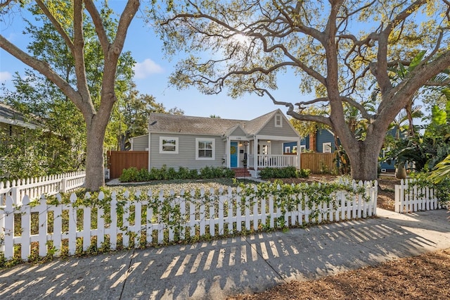 view of front of property with a porch and a fenced front yard