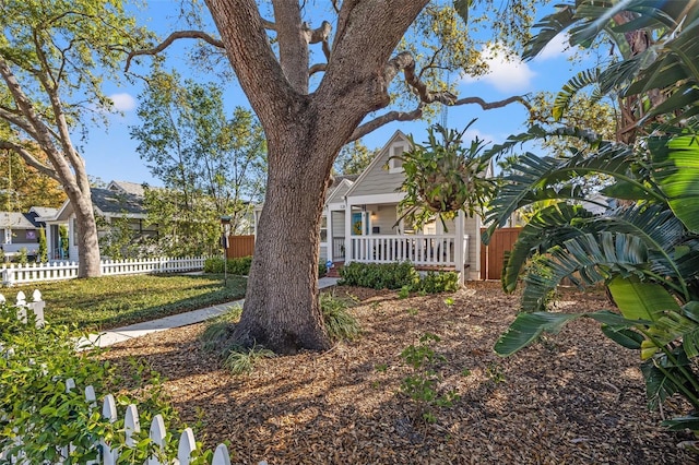 exterior space with fence and a porch